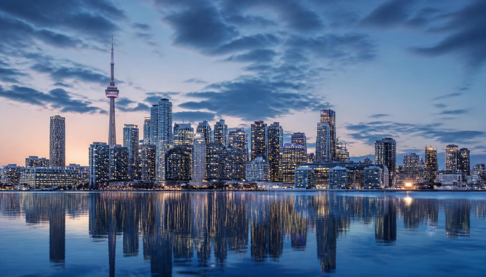 A Canadian city skyline at dusk, representing a client's arrival in Canada